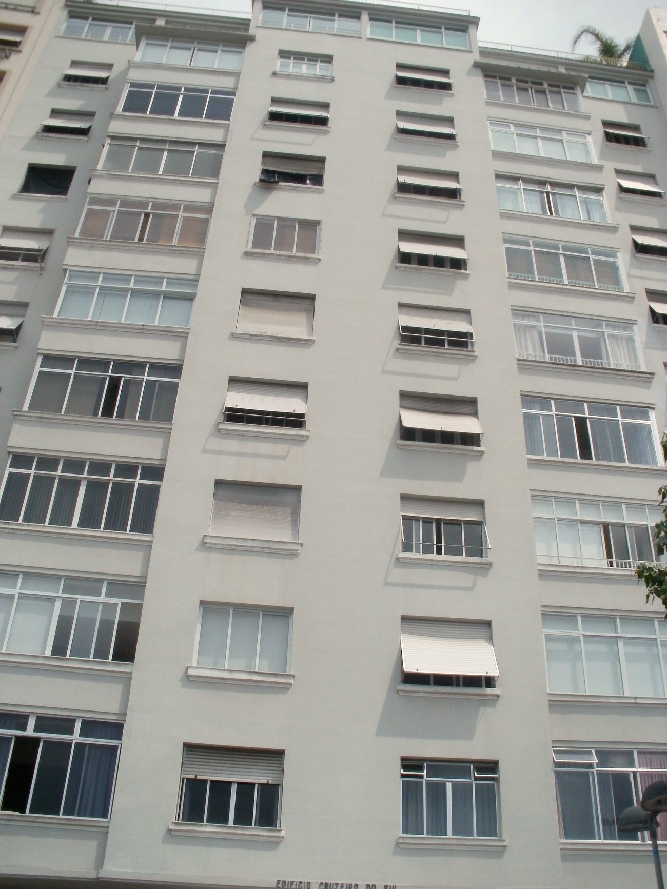 Weathered mid-century apartment facade on Avenida Atlantica facing Copacabana beach