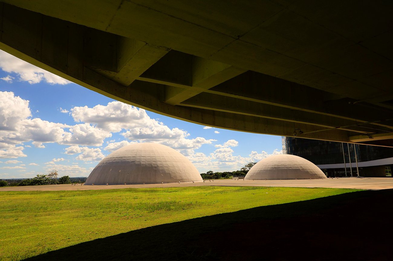 The domed buildings of Brazil's Superior Electoral Court headquarters in Brasília under a blue sky