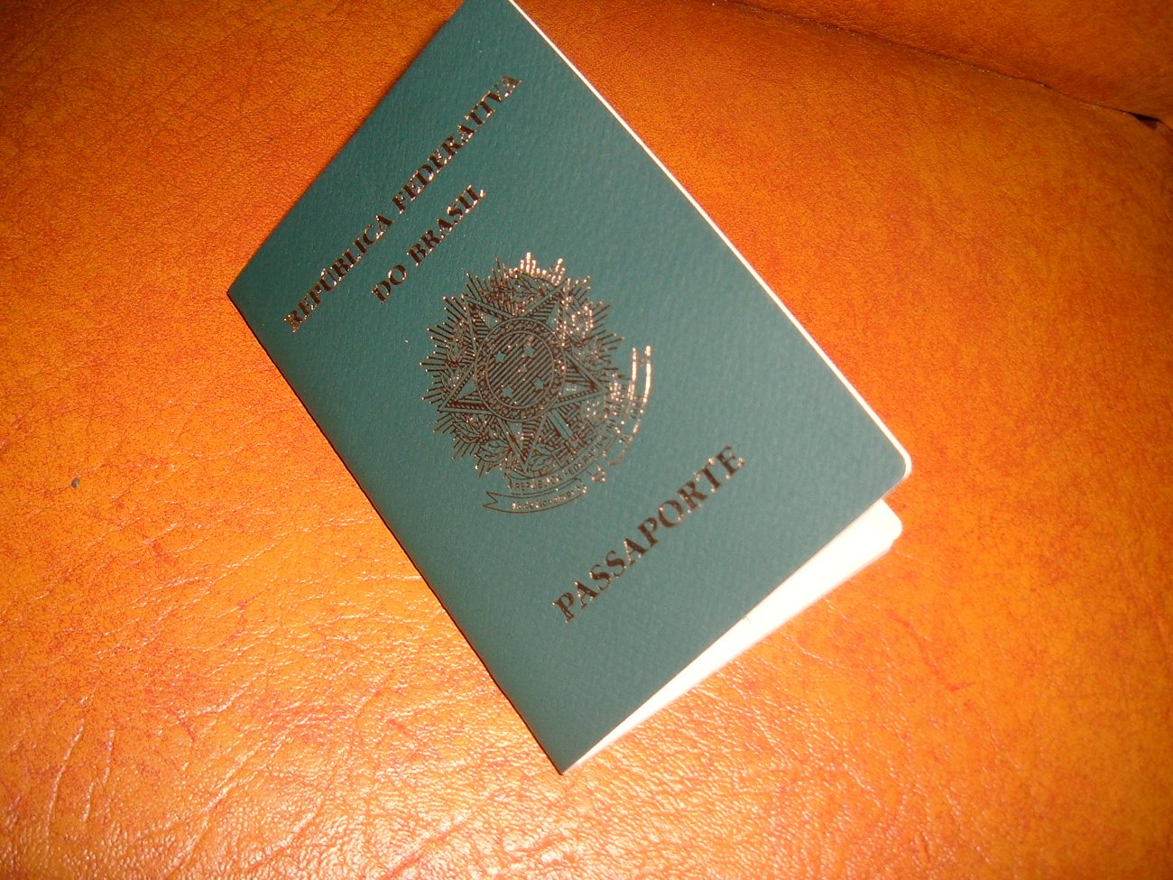 A passport and official documents laid out on a desk