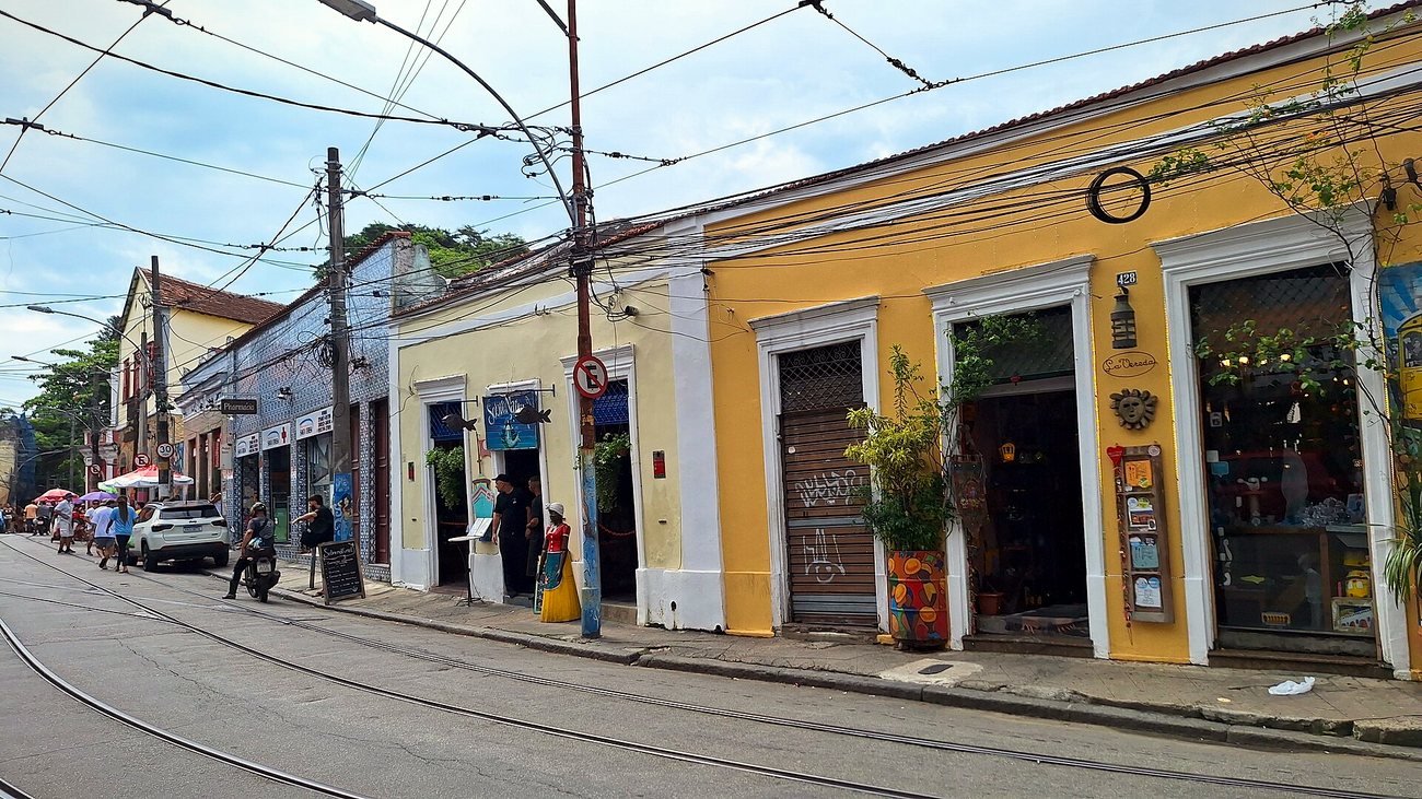 Colorful single-story colonial houses with shops on a tram-lined street in Santa Teresa, Rio de Janeiro