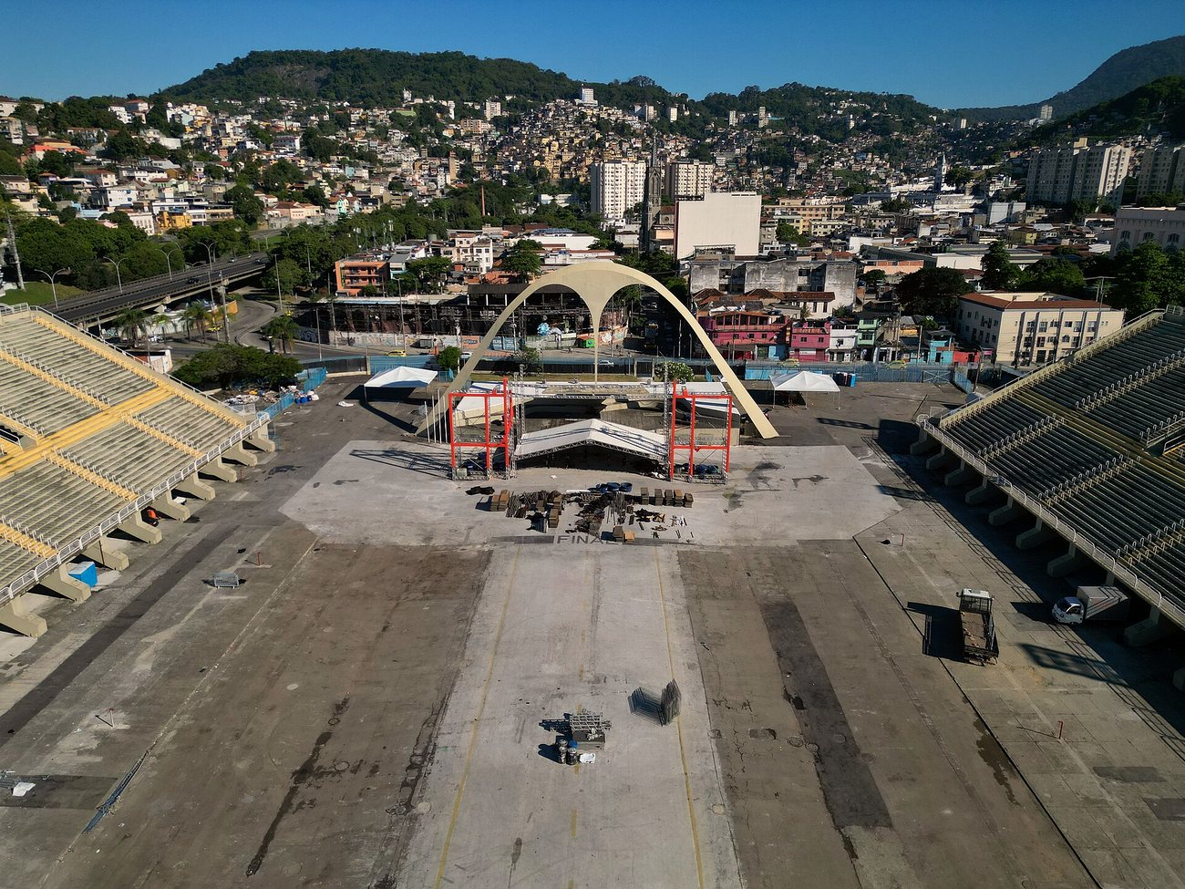 Aerial view of the Sambódromo on Marquês de Sapucaí in Rio de Janeiro outside Carnival, with empty stands, the main arch and the hillside neighborhoods behind